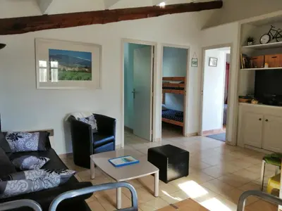 a living room with a couch and a table at L'oustau des euses in Bédoin