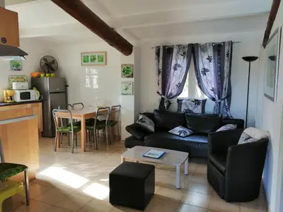 a living room with a couch and a table at L'oustau des euses in Bédoin