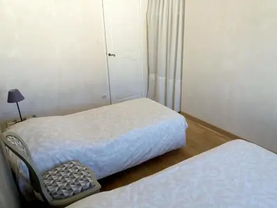 a room with two beds and a chair in it at Maison de charme avec piscine privée à Velleron in Velleron