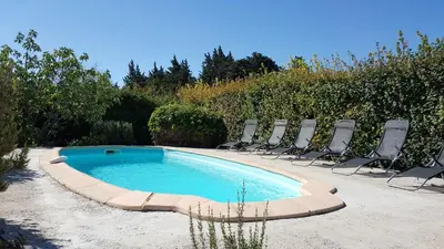 a swimming pool with lounge chairs and a swimming pool at Maison de charme avec piscine privée à Velleron in Velleron