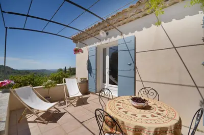 a patio with a table and chairs on a patio at Cerise en Provence in Venasque