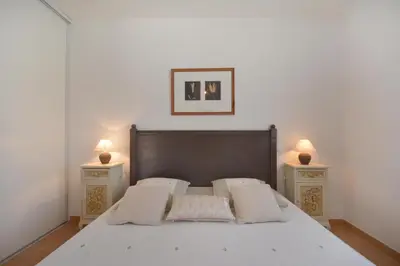 a bedroom with a bed with two night stands at Cerise en Provence in Venasque
