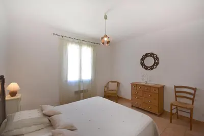 a bedroom with a bed and a dresser and a mirror at Cerise en Provence in Venasque