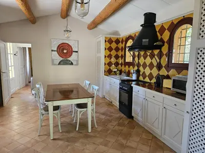 a kitchen with a table and a dining room at La Petite Yolande in Aix-en-Provence
