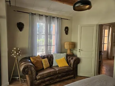 a living room with a couch and a window at La Petite Yolande in Aix-en-Provence