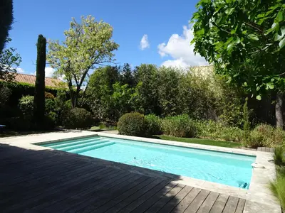 a swimming pool in a yard with trees at Domaine de la Girafe in Eyragues