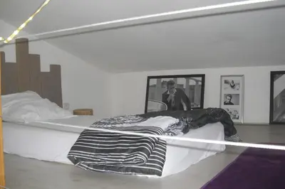 a bed in a room with a person in a mirror at Lou mas li Pitchoun 