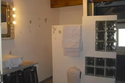 a kitchen with a refrigerator with towels on the wall at Lou mas li Pitchoun 