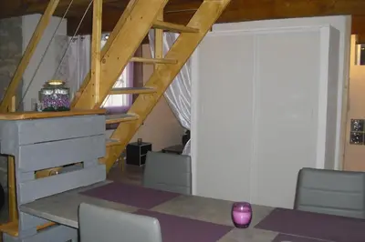 a room with a table and chairs and a staircase at Lou mas li Pitchoun 