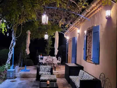 an outdoor patio with a table and chairs and lights at Sunny Provence Getaway in Villes-sur-Auzon