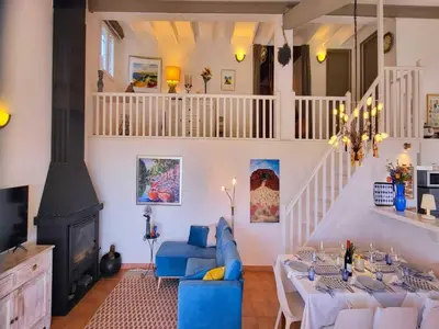 a living room with a blue couch and a fireplace at Sunny Provence Getaway in Villes-sur-Auzon