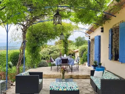 a patio with a table and chairs under a pergola at Sunny Provence Getaway in Villes-sur-Auzon