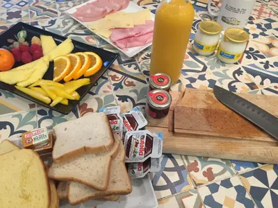 a table topped with a sandwich and a plate of food at Au Havre De Paix sainte victoire vauvenargues in Vauvenargues