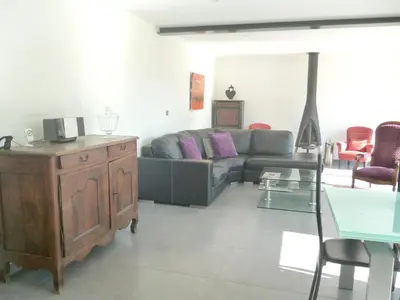 a living room with a couch and a table at Villa charmante à Eyragues avec piscine privée in Eyragues