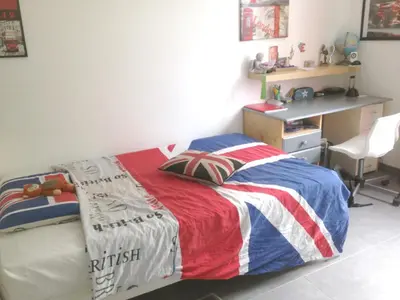 a bedroom with a bed with an american flag blanket at Villa charmante à Eyragues avec piscine privée in Eyragues