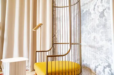 a yellow chair in a room with a window at Château de Mazan - Handwritten Collection in Mazan