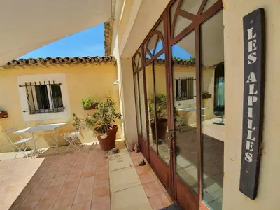 an entrance to a house with a glass door at Côté Provence in Le Thor