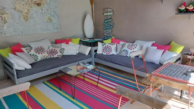 a living room with two couches with colorful pillows at Le Mas Des Bardes in Pernes-les-Fontaines