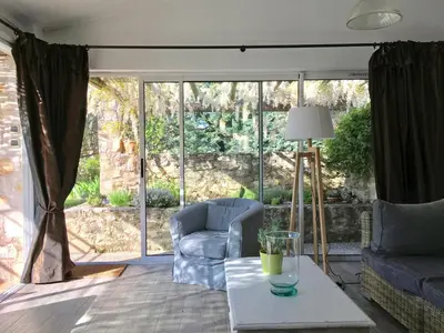a living room with a couch and a chair and a table at Le Petit Bastidon - Private pool - Gordes in Gordes