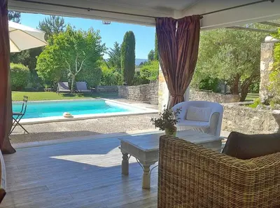 a patio with a table and chairs and a pool at Le Petit Bastidon - Private pool - Gordes in Gordes