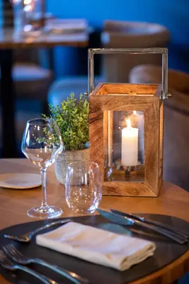 a candle sitting on top of a table with glasses at Domaine la Pierre Blanche in Eygalières