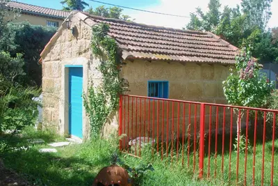 a small house with a red fence in front of it at Les Volets Bleus Provence in Salon-de-Provence