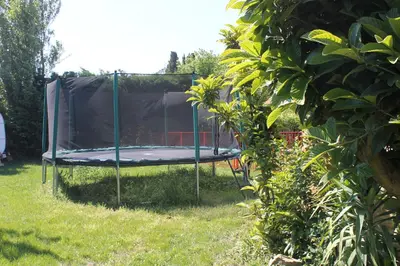a trampoline in the grass in a yard at Les Volets Bleus Provence in Salon-de-Provence