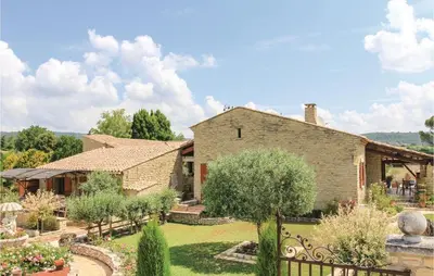 a large house with a garden in front of it at 3 Bedroom Stunning Home In Gordes in Gordes