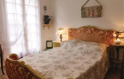 a bedroom with a bed and a window at 3 Bedroom Stunning Home In Gordes in Gordes