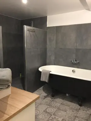 a bathroom with a bath tub and a shower at Les Suites du Cours & Spa in Aix-en-Provence