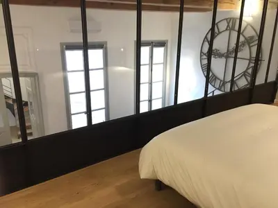 a bedroom with a bed and a large mirror at Les Suites du Cours & Spa in Aix-en-Provence
