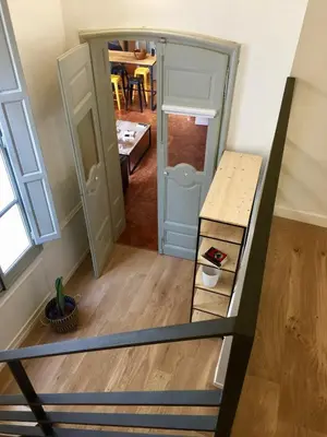 a room with a staircase and a room with a table at Les Suites du Cours & Spa in Aix-en-Provence