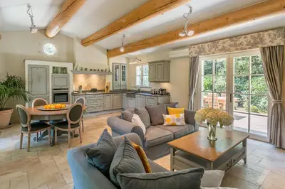 a living room with a couch and a table at Domaine Les Roullets in Oppède