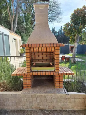 a brick oven sitting on top of a bench at La Maison du Moulin de Tartay in Avignon