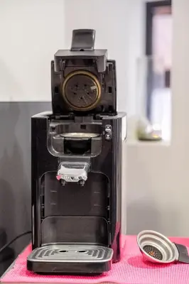 a coffee maker with a clock on top of it at Appart Hypercentre CLIM 2chb QuartierChic in Aix-en-Provence