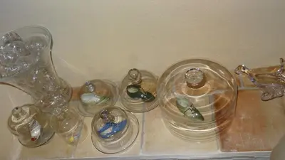 a group of glass containers sitting on a shelf at Chambre d'hôte Anais in Eyguières