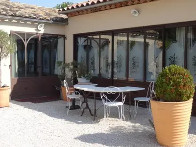 a table and chairs sitting outside of a house at Chambre d'hôte Anais in Eyguières