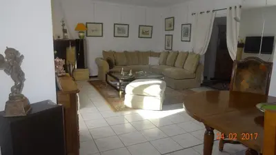 a living room with a couch and a table at La maisonnette in Crillon-le-Brave