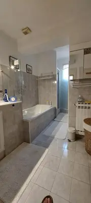 a large bathroom with a tub and a sink at La maisonnette in Crillon-le-Brave