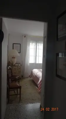 a bedroom with a bed and a window at La maisonnette in Crillon-le-Brave
