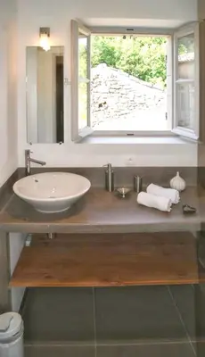 a bathroom with a sink and a window at Villa spacieuse à Oppède avec piscine et vue imprenable in Oppède