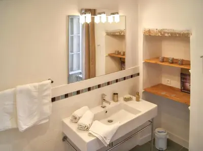 a white bathroom with a sink and a mirror at Villa spacieuse à Oppède avec piscine et vue imprenable in Oppède