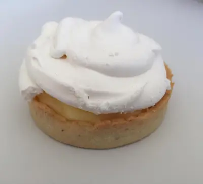 a cupcake with white frosting on a white surface at BB 12 LUBERON chambres d'hôtes contemporaines in Gordes
