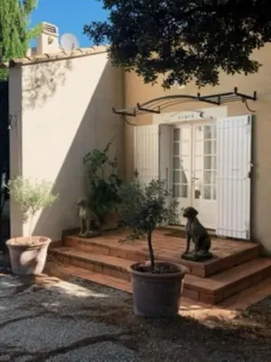 two cats sitting on the stairs of a house at L'Hymette in Blauvac