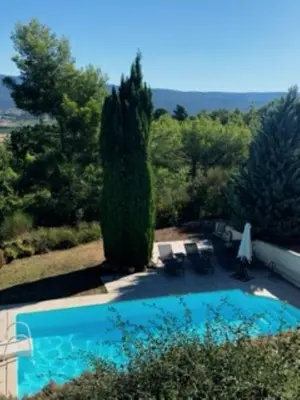 a swimming pool in the yard of a house at L'Hymette in Blauvac