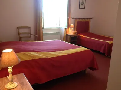 a hotel room with two beds and a lamp at Mas la Cigaliere in Venasque