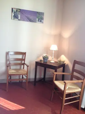 a room with two chairs and a desk with a lamp at Mas la Cigaliere in Venasque