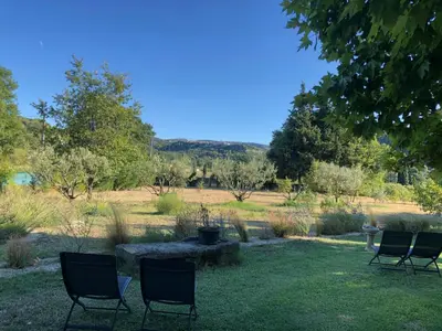 a group of chairs sitting in the grass at Mas la Cigaliere in Venasque