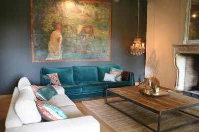 a living room with a blue couch and a coffee table at La Calade in Lourmarin