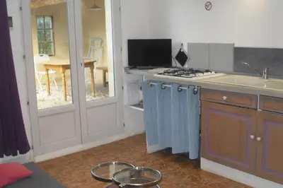 a kitchen with a sink and a stove top oven at Lou mas li Pitchoun 